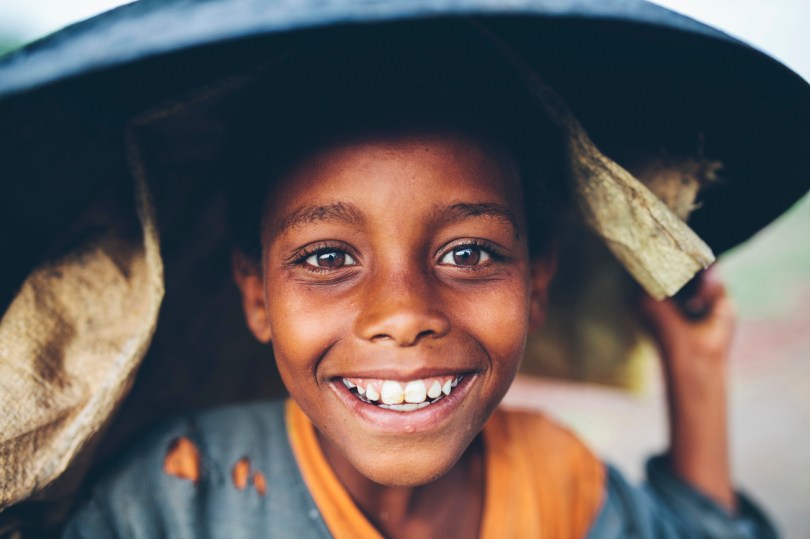 Fisherman's daughter sheltering from the rain, Lake Ziway, Ethiopia